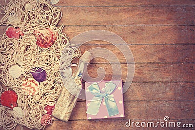 Net, gift and shells with bottle Stock Photo