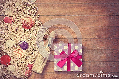 Net, gift and shells with bottle Stock Photo