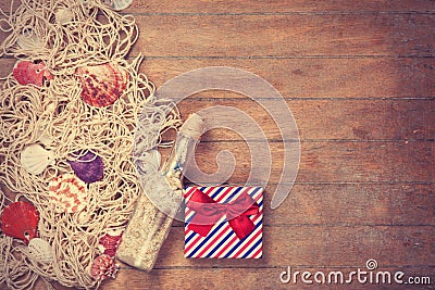 Net, gift and shells with bottle Stock Photo