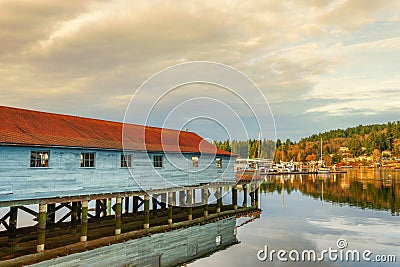 A net shed reflects in the Puget Sound at Gig Harbor Stock Photo