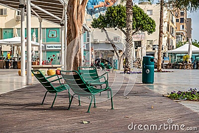 15/12/2018 Netanya, Israel, iron street chairs for passersby are chained to the waterfront on a warm winter Editorial Stock Photo