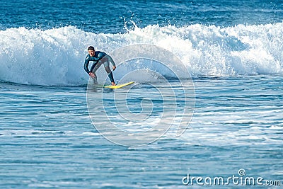 12/18/2018 Netanya, Israel, the surfer rides on the wave and perform tricks on a wave Editorial Stock Photo