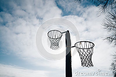 Netball goal ring and net against a blue sky and clouds at Hagley park, Christchurch, New zealand Stock Photo