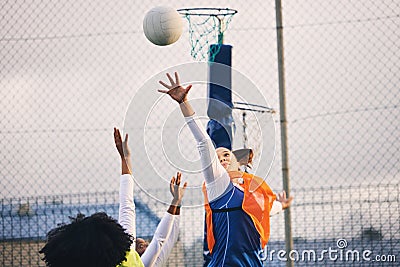 Netball, goal shooting and defense of a girl athlete group on an outdoor sports court. Aim, sport game and match Stock Photo
