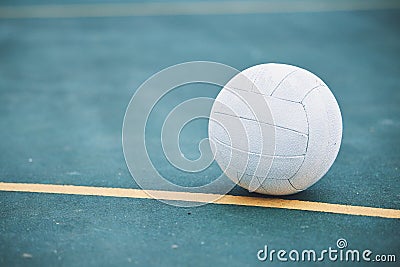 Netball on the ground on a sports court for a match, training or exercise outdoor on a field. Sport, fitness and white Stock Photo