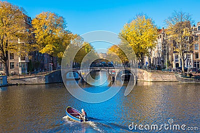 The Netherlands. Amsterdam canals. Bridge and boat Editorial Stock Photo