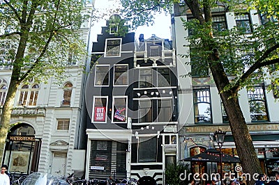 Netherlands, Amsterdam, 13 Spui, black three-story house between two white Editorial Stock Photo
