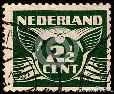 NETHERLANDS - CIRCA 1924: Postal stamp printed in the Netherlands (Holland), shows stylized animal bird flying dove Editorial Stock Photo