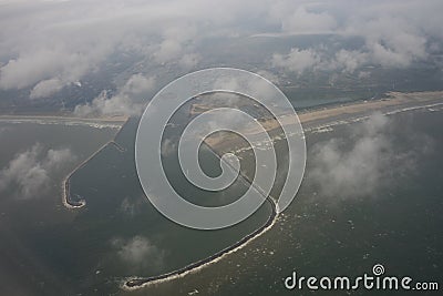 The Netherlands coastline, lighthouse and harbour viewed from the sky from a plane window Stock Photo