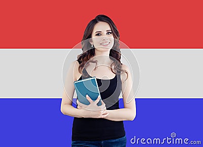 Netherlands concept with happy smiling woman against the Netherlands flag background. Travel and learn netherlandish language Stock Photo