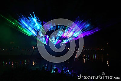 Laser show during public free event on public street and water with small ships parad Editorial Stock Photo