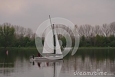 Netherlands, Roermond, Maasplassen, on the lake a Valk Jolle, a small open sailing boat with gaff sails Editorial Stock Photo