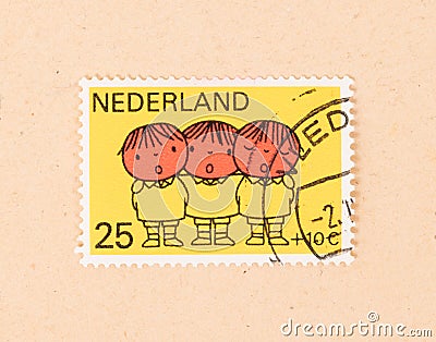 THE NETHERLANDS 1960: A stamp printed in the Netherlands shows three children singing, circa 1960 Editorial Stock Photo