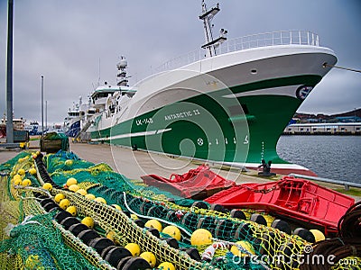 With nets in the foreground and moored at Lerwick harbour, the Antarctic II LK 145 - one of the Shetland pelagic fishing fleet Editorial Stock Photo
