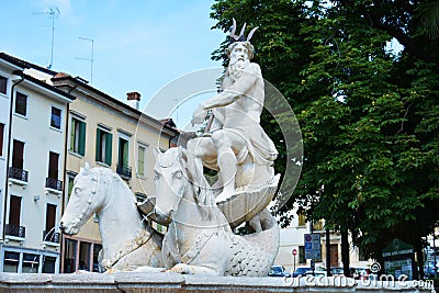 Nettuno fountain white romantic sculpture, detail and trees, in Conegliano Veneto, Treviso, Italy Editorial Stock Photo