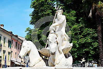 Nettuno fountain white sculpture, detail and trees, in Conegliano Veneto, Treviso, Italy Editorial Stock Photo