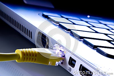 Network cable plugged in the laptop Stock Photo