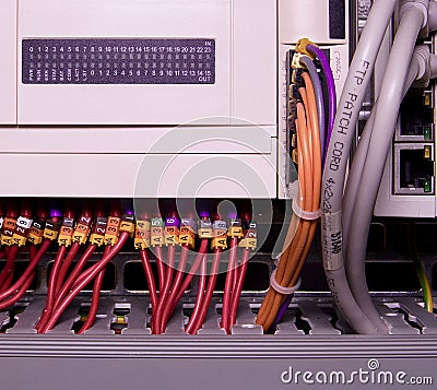 Network cables connected to switch - close up of data center hardware. Multi colored wires Stock Photo