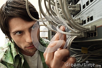 Network Engineer Working In Server Room Stock Photo