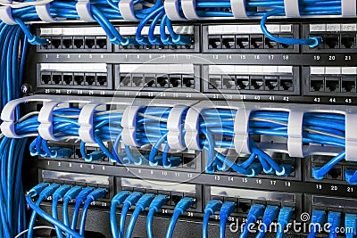 Network panel, switch and internet cable in data center. Black switch and blue ethernet cables, Data Center Concept. Stock Photo