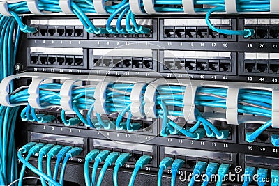 Network panel, switch and internet cable in data center. Black switch and blue ethernet cables, Data Center Concept. Stock Photo