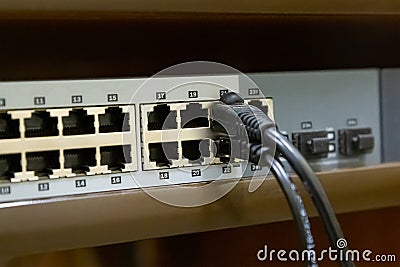 Network switch to create a single computer system and peripherals with an inserted cable Stock Photo
