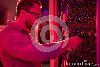Network technician fixing supercomputer Stock Photo