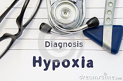 Neurological diagnosis of Hypoxia. Neurological hammer, stethoscope and doctors glasses lie on doctor workplace on sheet of notebo Stock Photo