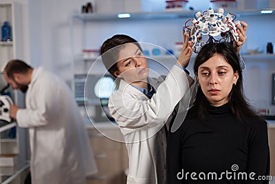 Neurologist doctor woman putting eeg scanner on patient head analyzing brain evolution Stock Photo