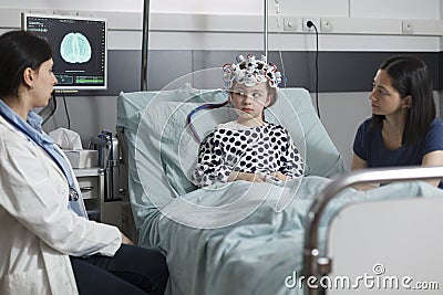 Neurology specialist measuring neurologic disease evolution of sick kid sitting in pediatric healthcare facility Stock Photo