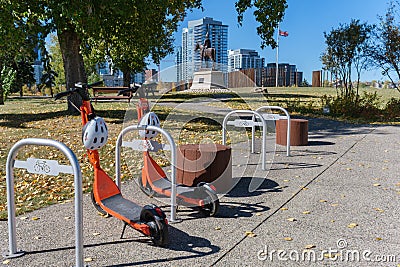 Neuron electric scooters parked at a rack in Calgary, Canada Editorial Stock Photo