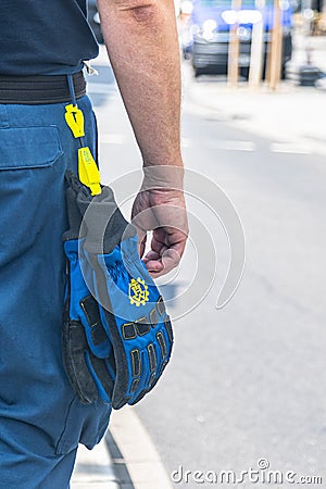 Part of a volunteer of the German `Technisches Hilfswerk` Federal Agency for Technical Relief with the sign `THW` on gloves Editorial Stock Photo