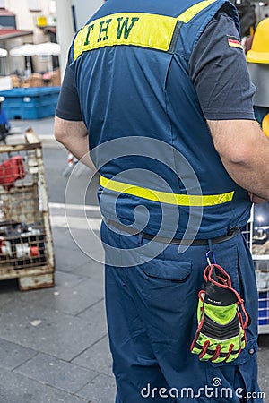 A volunteer of the German `Technisches Hilfswerk` Federal Agency for Technical Relief with the sign `THW` on his back Editorial Stock Photo