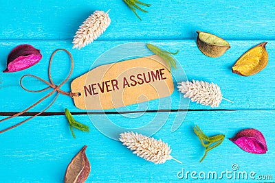 Never assume text on paper tag Stock Photo