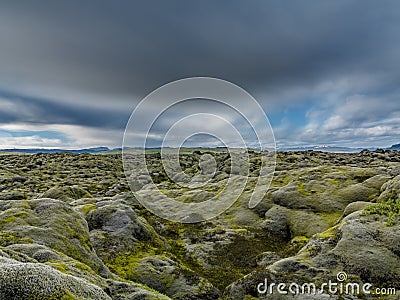 Never-ending Lava fields in Iceland with mountains, long exposure Stock Photo