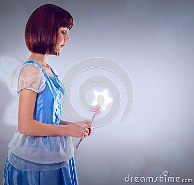 Never stop believing in magic. A cropped shot of a fairy godmother in a blue gown. Stock Photo