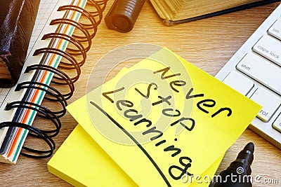 Never stop learning written on a stick. Lifelong learning concept. Stock Photo