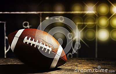 New American soccer ball on table against blackboard with scheme of football game Stock Photo