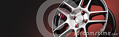 The new automotive alloy wheel is light and sporty red with shiny spokes on a red-black gradient background, beautiful Stock Photo