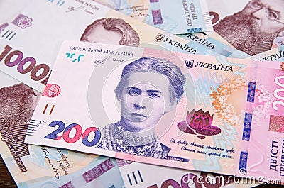 New banknote of 200 hryvnia against the background of 1000 hryvnia banknotes. Financial concept. Stock Photo