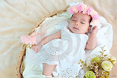 New born baby sleep on the basket or on the bed and keep smile with everyone. Feeling love the new born baby and need to take care Stock Photo