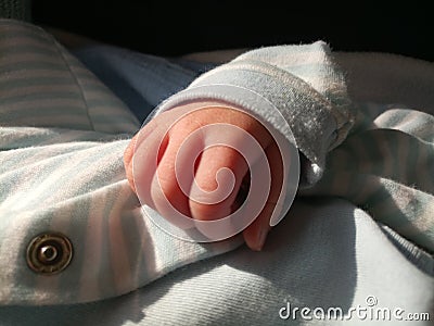Small babys hand clenched in a fist Stock Photo