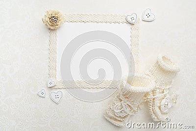 New Born or baptism Greeting Card. Blank paper with baby girl shoes on biege background. Flat lay. Top view. Stock Photo