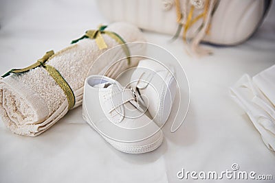 New born white baptism shoes and towel Stock Photo