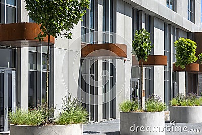 New building facade with entrances to offices, stores, cafe and modern city landscaping details Stock Photo