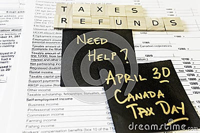 New Canadian personal tax forms and letter tiles showing refunds and taxes Stock Photo