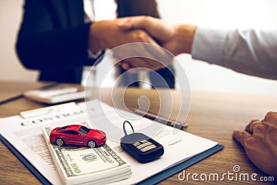 New car buyers and car salesmen are shaking hands to make agreements about car sales Stock Photo