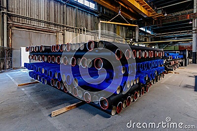 New cast iron pipes for pipeline construction in warehouse Stock Photo