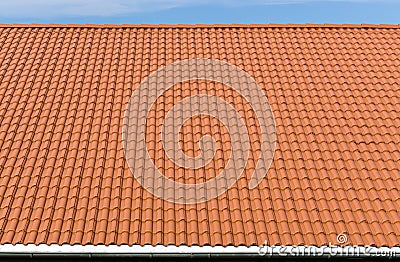 New and clean red tiles roof with rain pipe Stock Photo