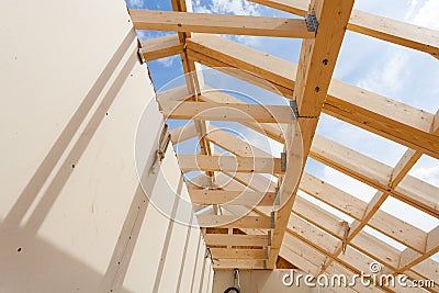 New construction home framing against blue sky, closeup of ceiling frame.with plasterboard wall Stock Photo